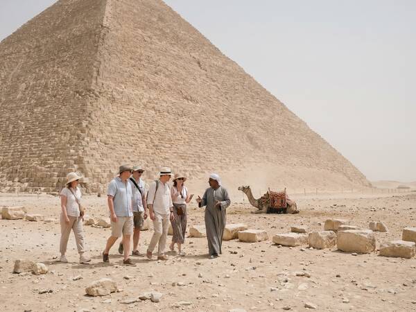 Tourists with a guide at the foot of the Red Pyramid of Dahshur