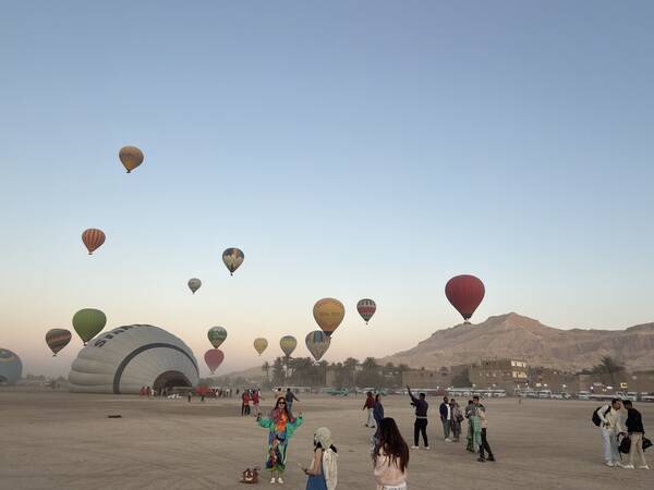 Balloons inflating at sunrise on the West Bank