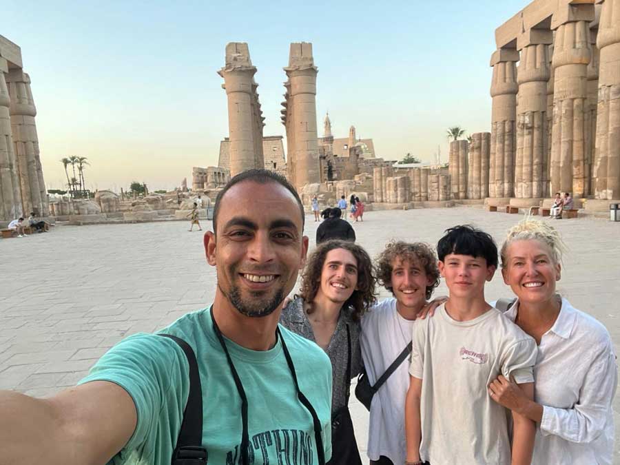 Luxor Temple at sunset, our guide with a family on tour